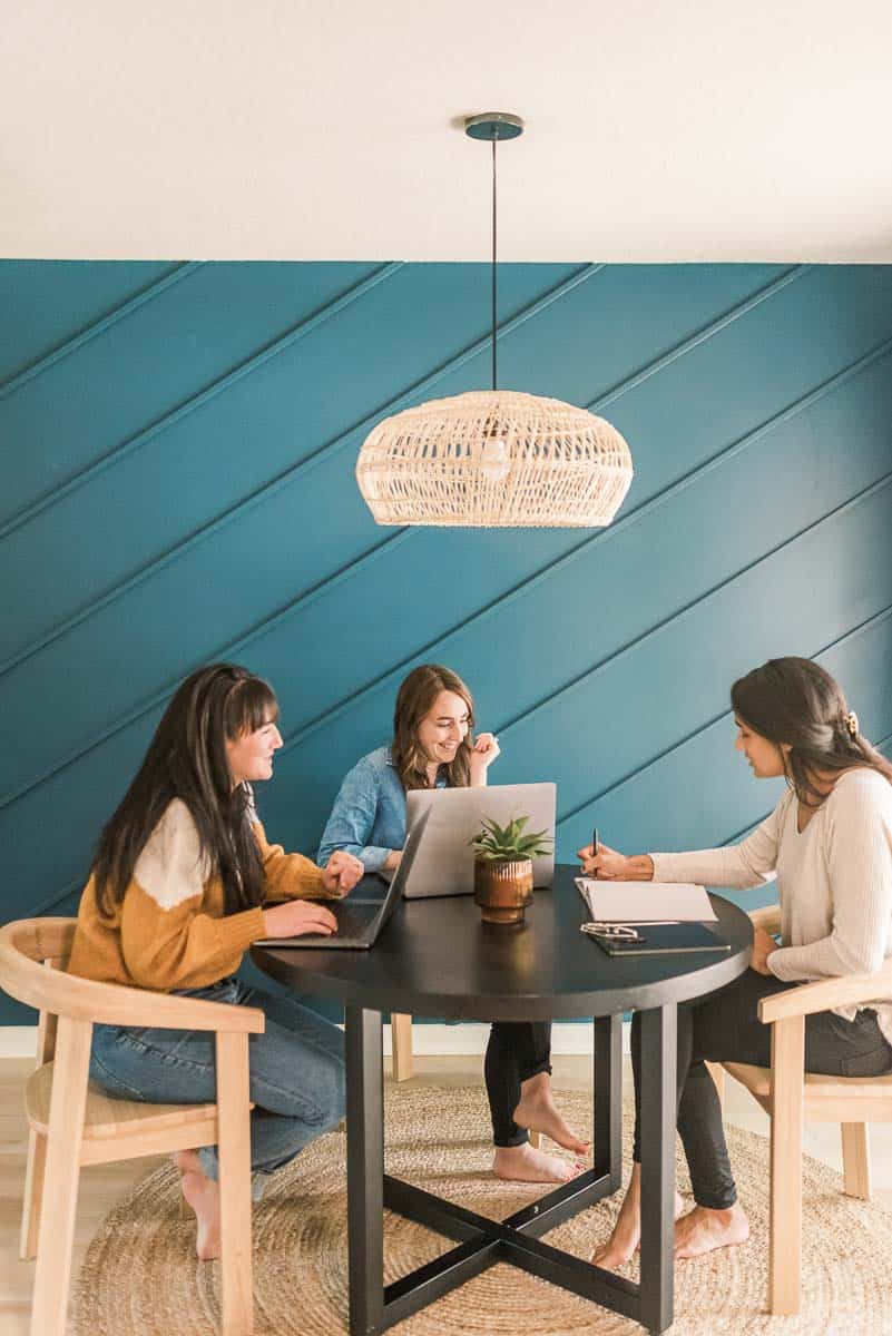 opened laptop on desk with blue accent wall