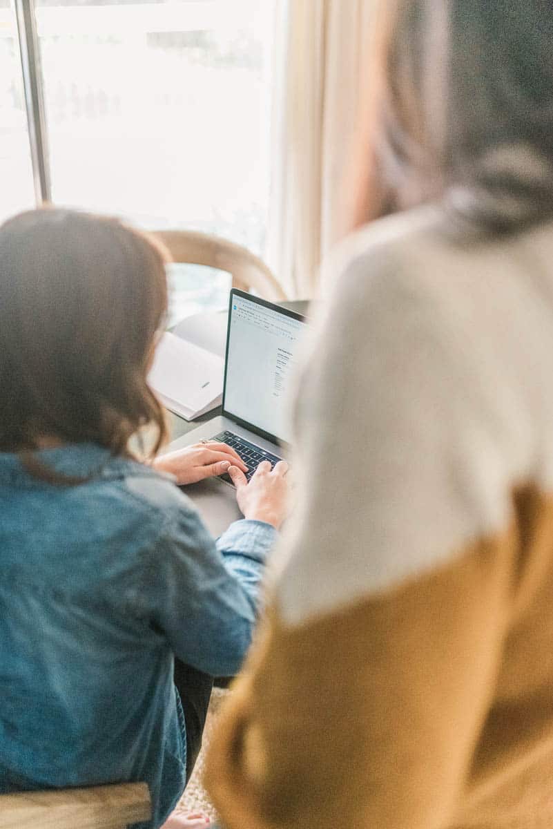 opened laptop on desk with blue accent wall