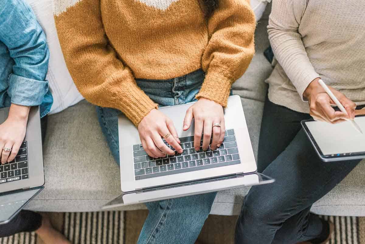 opened laptop on desk with blue accent wall